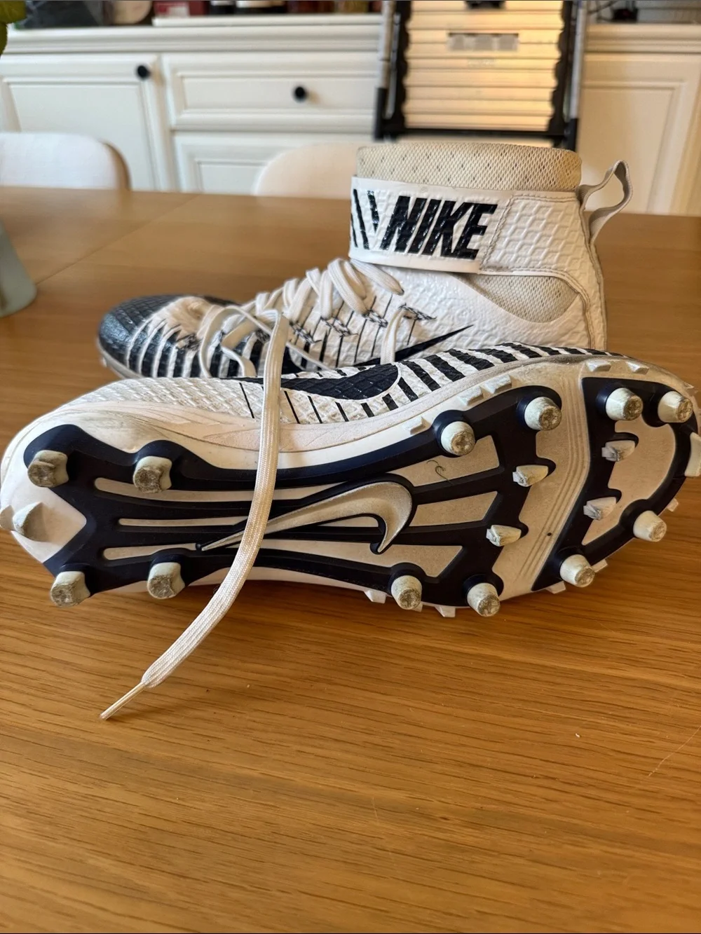 Nike White and Black High-Top Cleats with Graphic Stripes